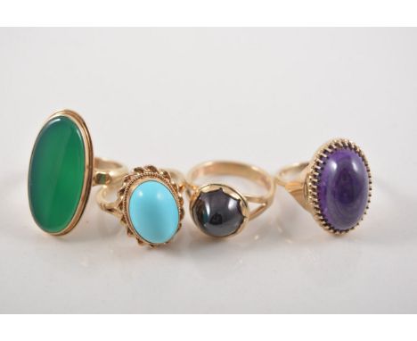 Four 9 carat yellow gold dress rings, an oval cabochon cut amethyst, claw set, an oval cabochon cut turquoise, collet set wit