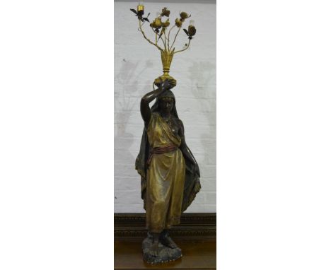 Goldscheider style lamp, designed as a lady carrying an urn, floral branches to the lights, naturalistic base, height overall