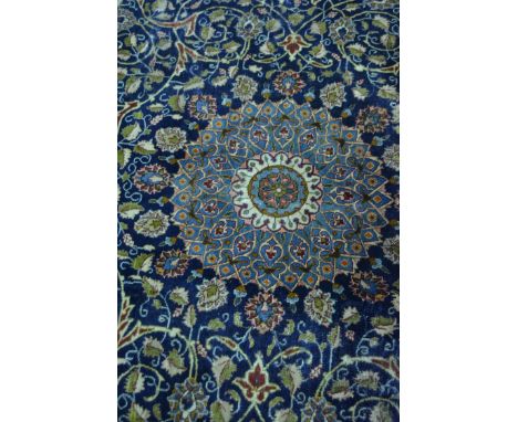 Mehsed carpet, central light blue ground floral medallion on a dark blue field with trellis pattern within guards, broad mean