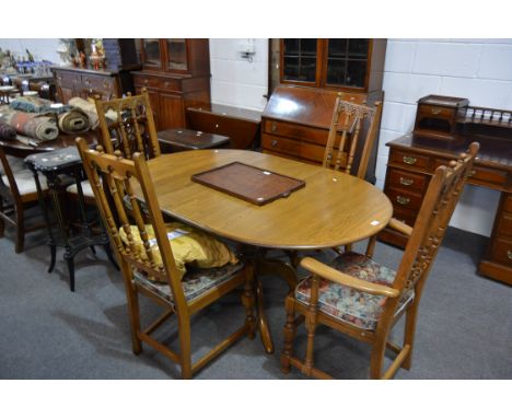 Ercol oak dining suite, pedestal table with oval extending top, with one extra leaf, turned column, four splayed legs, the to