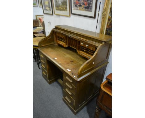 American oak roll top desk, serpentine tambour, twin pedestals, each fitted with four graduating drawers, plinth base, width 