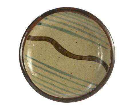 A Leach Pottery, St Ives, standard ware plate with speckled oatmeal glaze and linear brushed decorationDiameter 29cmImpressed