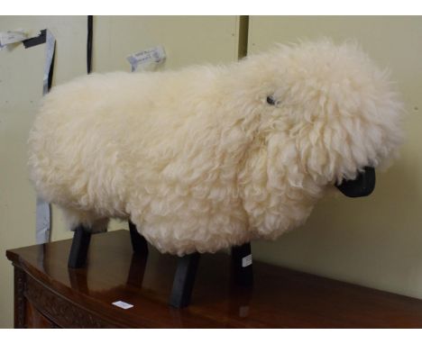 An ebonised wood and wool model of a sheep in the manner of Lalanne 