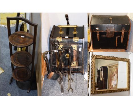 A gilt framed rectangular mirror, a leather dome topped trunk, a three tier folding cake stand, a cast iron companion set, an
