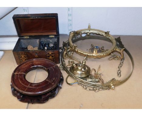 A Victorian walnut and inlaid tea caddy, the hinged lid enclosing two compartments filled with draughts counters and chess pi