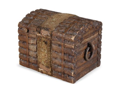 AN EARLY 20TH CENTURY BLACK FOREST CARVED COMPACT CHEST, of rectangular form, with hinged domed lid and carved loop side hand