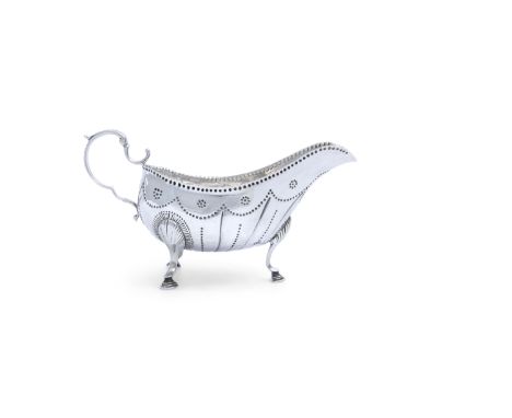 AN IRISH GEORGE III SILVER SAUCEBOAT, Dublin c.1770 (no date letter), maker's mark of Matthew West, of helmet form, with punc