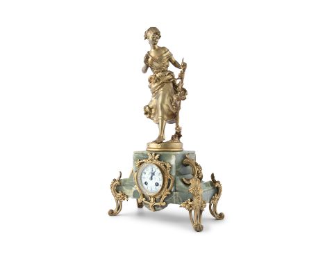 A FRENCH ONYX AND GILTMETAL FIGURAL MANTLE CLOCK, late 19th century, tiled Plaisir d' Ete surmounted with the figure of a you