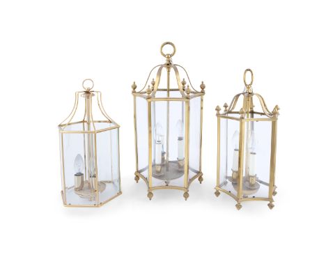 THREE BRASS FRAMED HALL LANTERNS, each with domed top and suspension loops, above hexagonal body, containing three-light arra