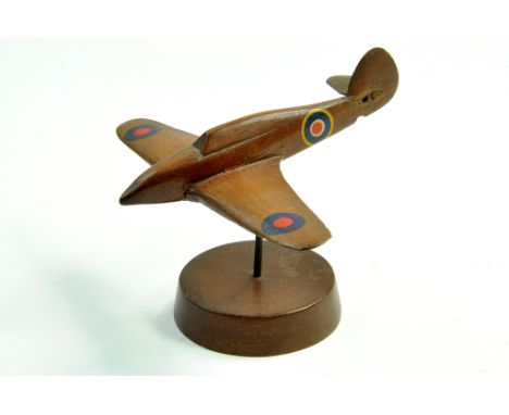 A wooden model, vintage, of an RAF Spitfire with stand. Some damage. Rare. Note: We are happy to provide additional images of