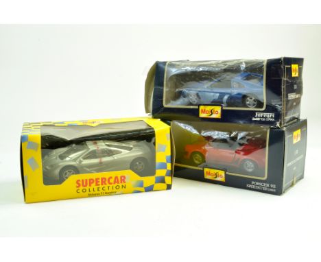 Trio of diecast cars comprising 1/24 Maisto issues. Porsche, Ferrari and McLaren. Generally excellent in boxes. Note: We are 