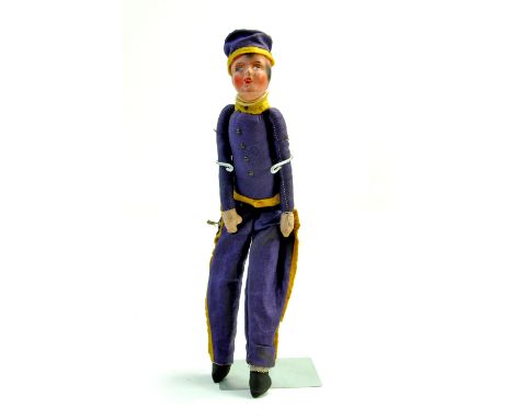 An unusual, likely rare, 10 ½” early 1900’s Bellhop Cloth Boy. Theatrical doll. Purple uniform with yellow trimmings. Hand pa