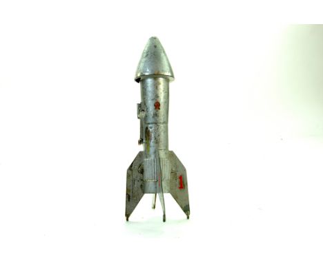 An unusual large metal US issue savings bank in the form of a rocket. Damaged hence fair only.  Note: We are happy to provide