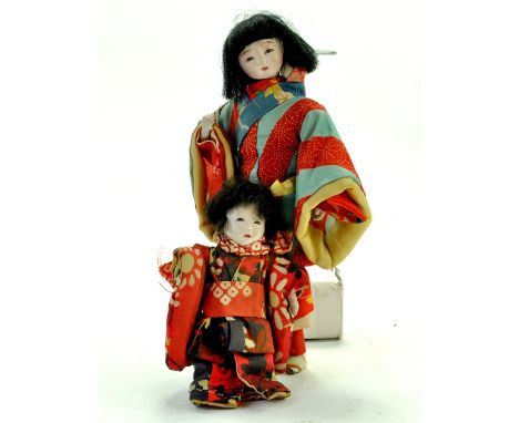 Duo of Chinese / Asian Bisque Dolls. In bright vibrant dress. Condition is generally good to very good.  Note: We are happy t