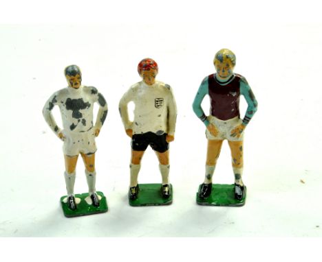 Keymen Football Series figures comprising Bobby Moore, Alan Ball and one other. Generally fair to good.  Note: We are happy t