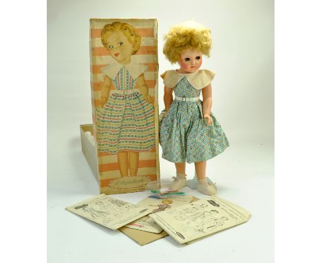 A well preserved and beautiful 19” 1950s Pedigree "Elizabeth" the Dressmaking Doll all Original in box. Hard Plastic, blue fl