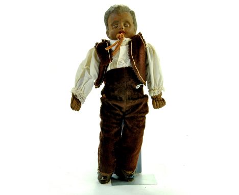 An extremely unusual antique doll comprising a 'Clay' Compositional very heavy headed boy figure on cloth body. Likely to be 