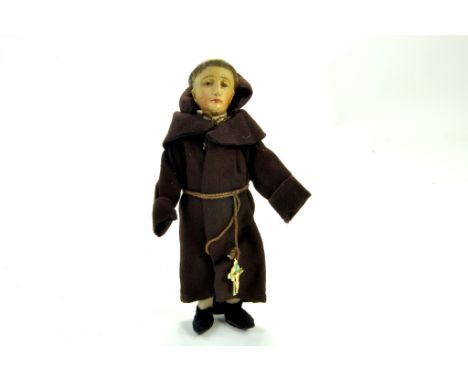 An interesting, likely antique 8” Friar/Monk Doll. No markings, bisque head cloth arms and legs original costume.  Note: We a