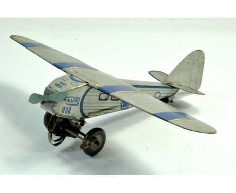 A 1933 Mettoy Mechanical Single Engine Tinplate Monoplane, silver with blue trim. Replacement propeller. Generally good.  Not