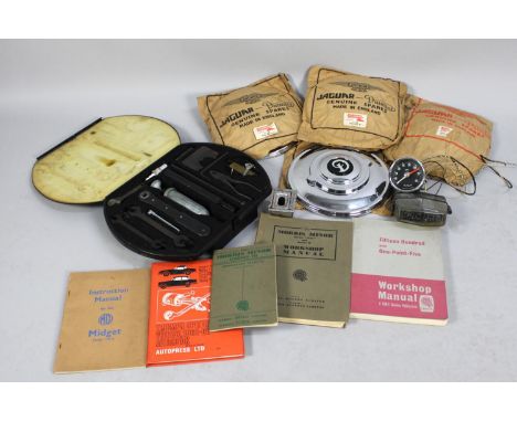 A Collection of Daimler Vintage Wheel Trims, Jaguar Spare Wheel Tool Kit, Various Instruction Manuals for Morris Minor etc MG