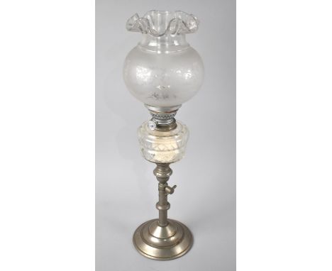 An Edwardian Rise and Fall Oil Lamp with Glass Reservoir, Etched Shade and Chimney. 50cm high 