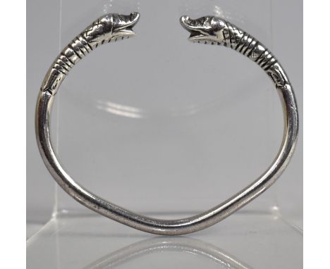A White Metal Bangle with Dolphin Head Ends 