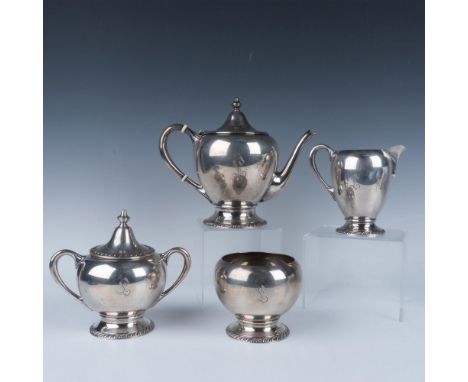 Gorgeous sterling silver set, features an elegant ornate pattern, monogramed with the letter L. Includes: One tea pot which w