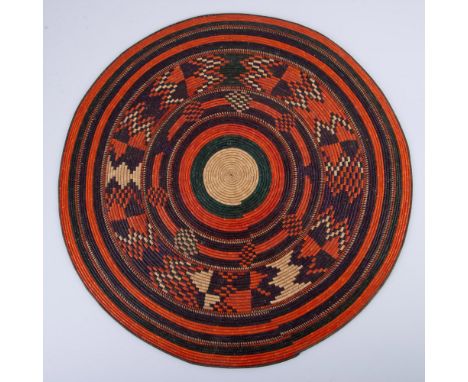 Native-style handmade coil flat tray or decorative piece. Used to be hung on the wall with a thread on the back of the work. 