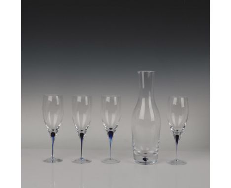 Four wine glasses and one carafe, each adorned with a sophisticated deep blue accent. Orrefors Sweden manufacturing sticker. 