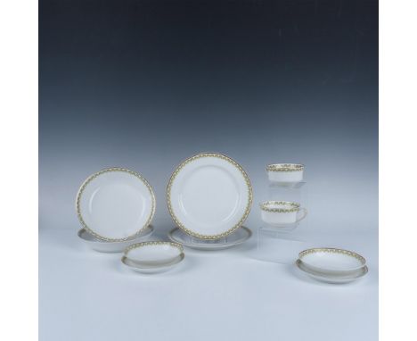 White porcelain dishes with red and green garlands and gilt trims on the rim. The collection includes: 2 plates (8.75"W x 1"H