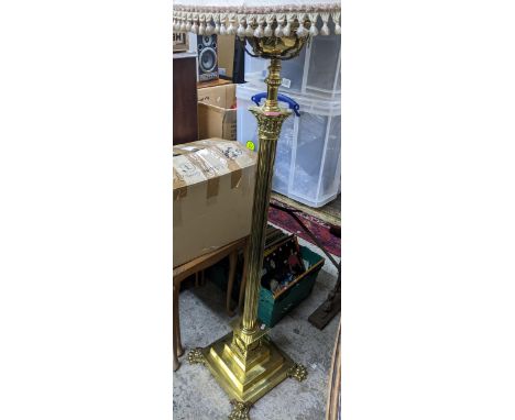 A brass column floor standing standard lamp converted from an oil lamp, Corinthian column on square stepped base and lion paw