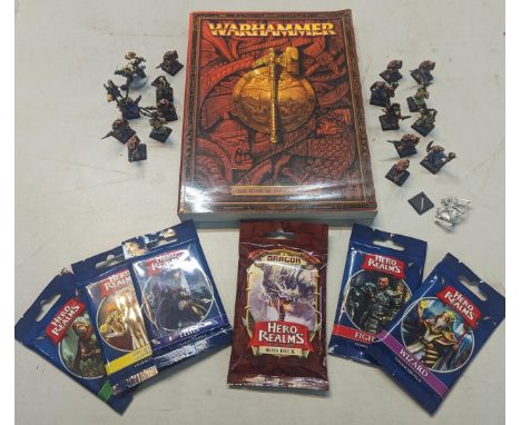 A Warhammer game book, along with model figures of characters and six unopened packs of Hero Realms cards Location: 