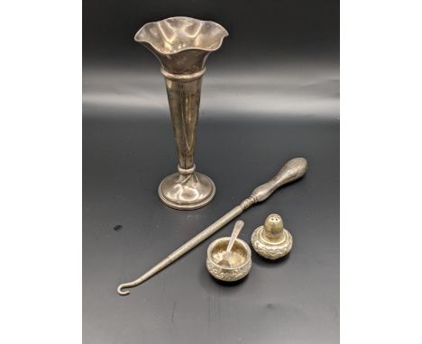 A silver weighted vase, London 1918, together with a silver handled button hook, and white metal condiments, total weight 209