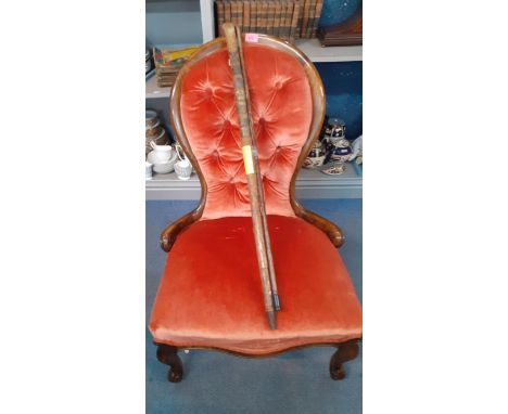 A Victorian nursing chair with apricot velvet upholstery together with a Swiss walking stick and a vintage walking caneLocati