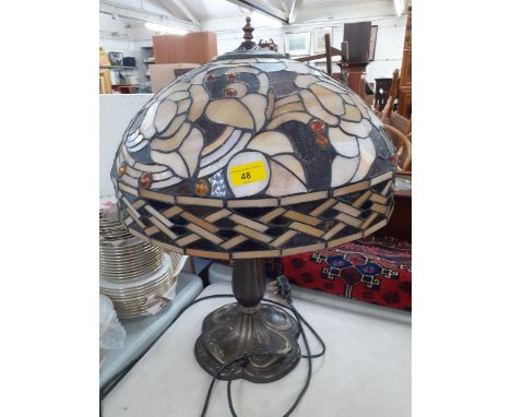 A Tiffany style table lamp, the shade in tones of brown with inset amber coloured beads, Location:RAB 