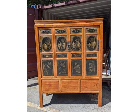 A Chinese black lacquered pine marriage cabinet with four panelled doors decorated with figures and birds, 177cm h x 130cm wL