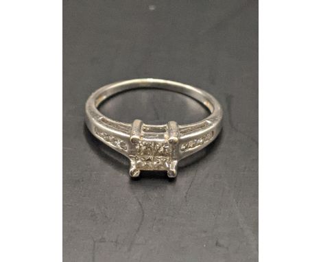 An 18ct white gold ring set with four central diamonds and four diamonds to each shoulderLocation: CAB1 