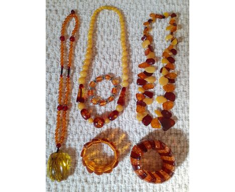 A group of vintage amber and amber effect necklaces and bracelets. Location:Cab 