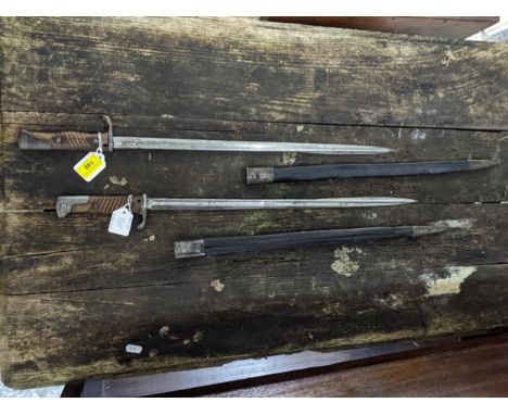 Two German M1898 bayonets, wooden handle with metal end, long narrow blade, 52cm long, in leather scabbard stamped 5BFURT to 