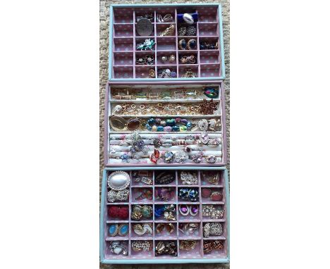 Three modern leather 'Stackers' jewellery compartmental trays containing mid to late 20th Century clip-on earrings to include