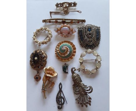 A small quantity of early to mid 20th Century brooches and a shoe clip to include a silver coloured and marcasite peacock bro