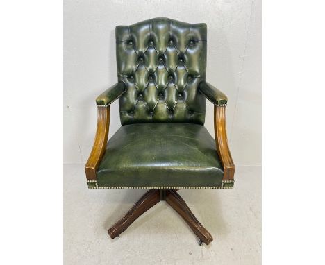 Antique style button back  captains chair upholstered in green leather 