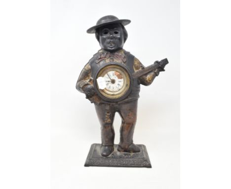 An American automaton clock, the cast metal case in the form of a banjo player, some damage, 39 cm high

 