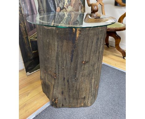 A tree trunk section glass top occasional table, diameter 66cm, height 62cm