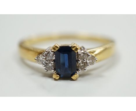 A modern 18ct gold and single stone sapphire set ring, with six stone diamond set shoulders, size R, gross weight 3.2 grams.