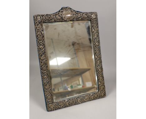 A late Victorian repousse silver mounted dressing table mirror, Henry Matthews, Chester, 1900, 48.3cm.