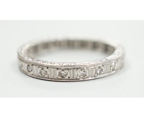 A white metal, stamped plat and diamond chip set full eternity ring, size K, gross weight 3.7 grams.