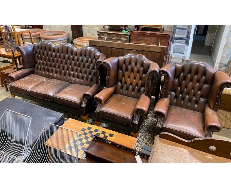 A Victorian style button brown leather three piece suite