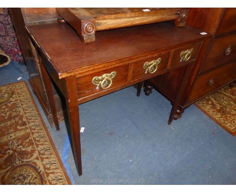 A circa 1900 Oak side Table having light and darkwood beading to the top, three frieze drawers with elaborate brass back plat