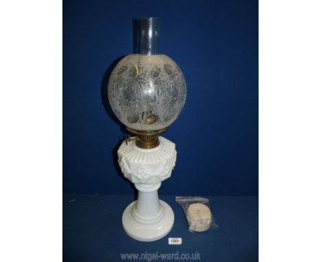 A double burner oil Lamp with opaque glass reservoir and etched glass shade, 23" high, plus spare wick.